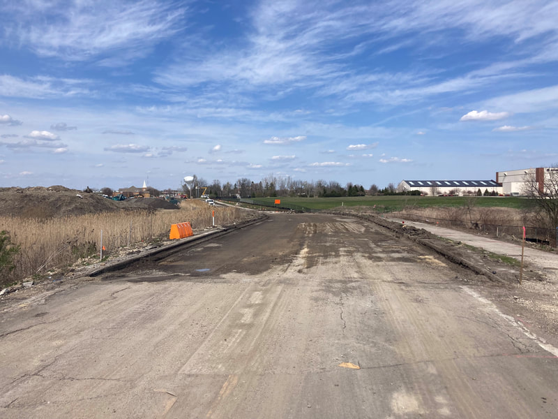 Looking north from the railroad tracks; pavement removal completed to the Airport Access Road
