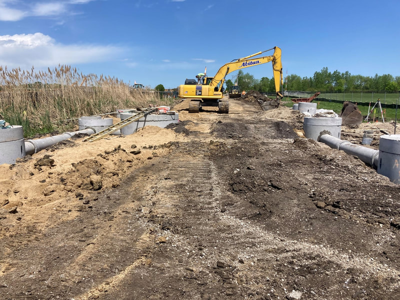 Installation of six storm sewer structures at the low point in the new roadway
