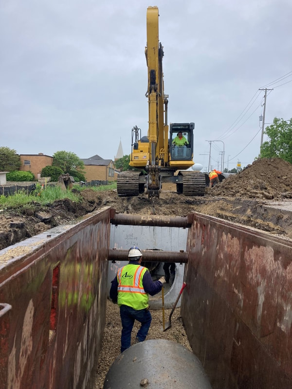 This connection between the existing pipe at the north end of the project and the newly installed pipe completed the northern storm sewer system