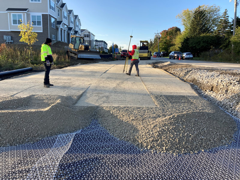 The first layer of gravel that will lock into the stabilization grid to provide a strong layer for larger equipment to drive on