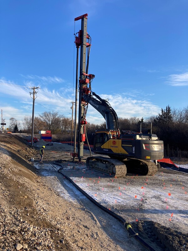 The column drill rig pushes existing material to the sides of the auger shaft and down 15-25 feet, then pumps concrete grout into the ground to create a rigid column